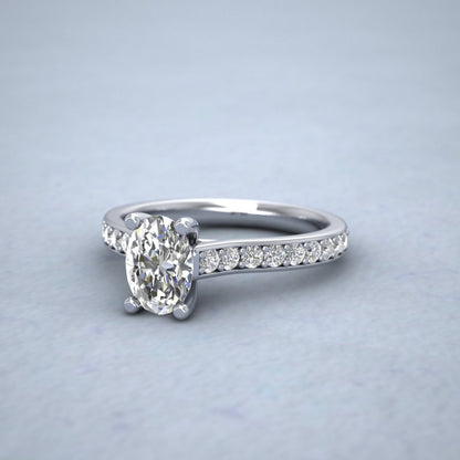 Platinum Four Claw Set Oval Diamond Ring With Shoulder Stones