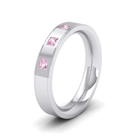 <p>9ct White Gold Princess Cut Pink Sapphire And Line Patterned Flat Wedding Ring.  4mm Wide And Court Shaped For Comfortable Fitting</p>