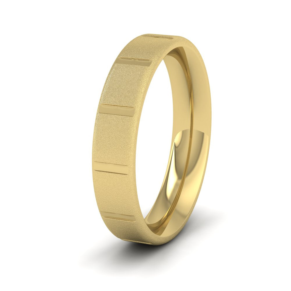 <p>18ct Yellow Gold Soft Edged And Patterned Flat Wedding Ring.  5mm Wide And Court Shaped For Comfortable Fitting.  With A Fine Sparkle Finish</p>